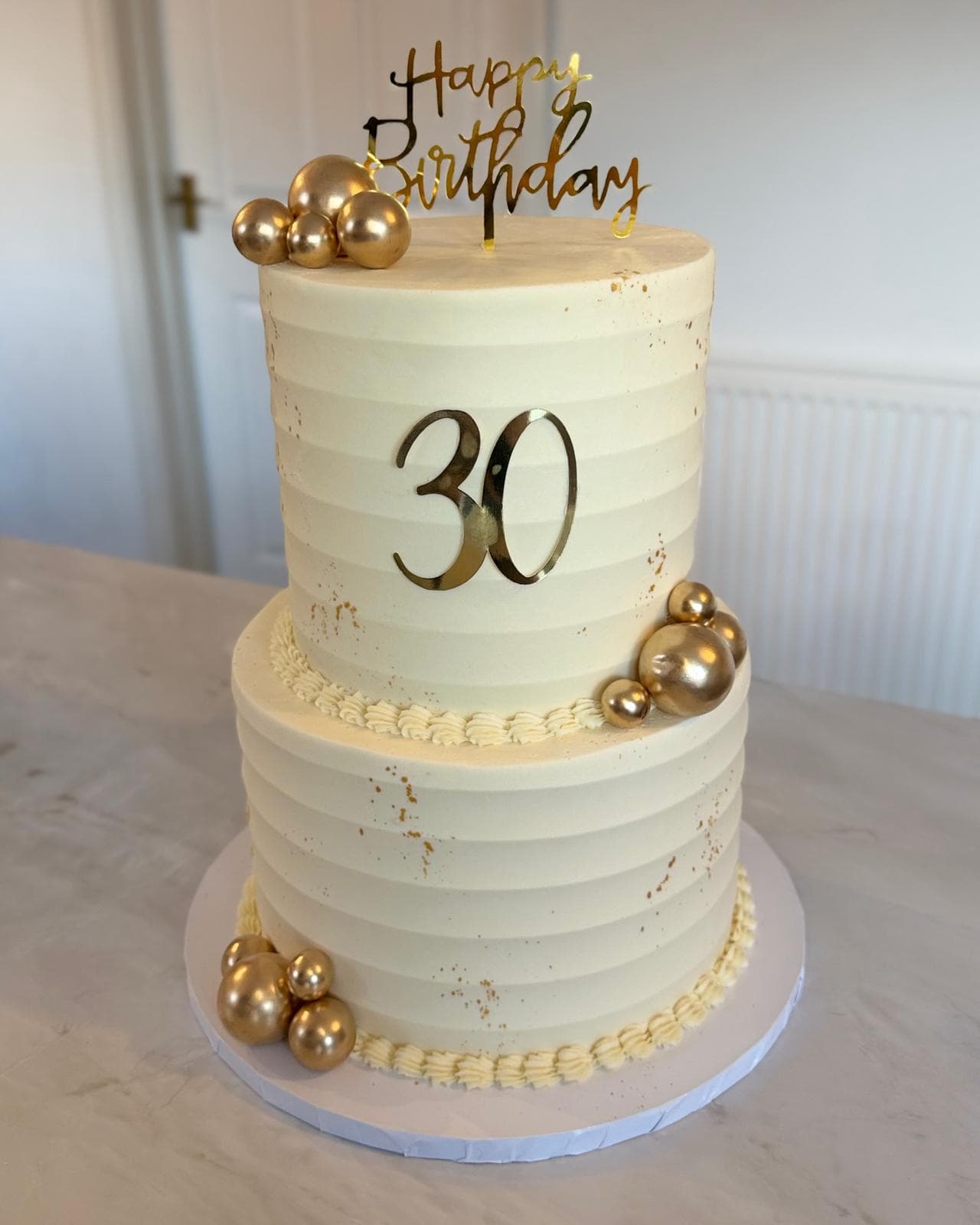 Two tier 30th birthday cake with gold decorations