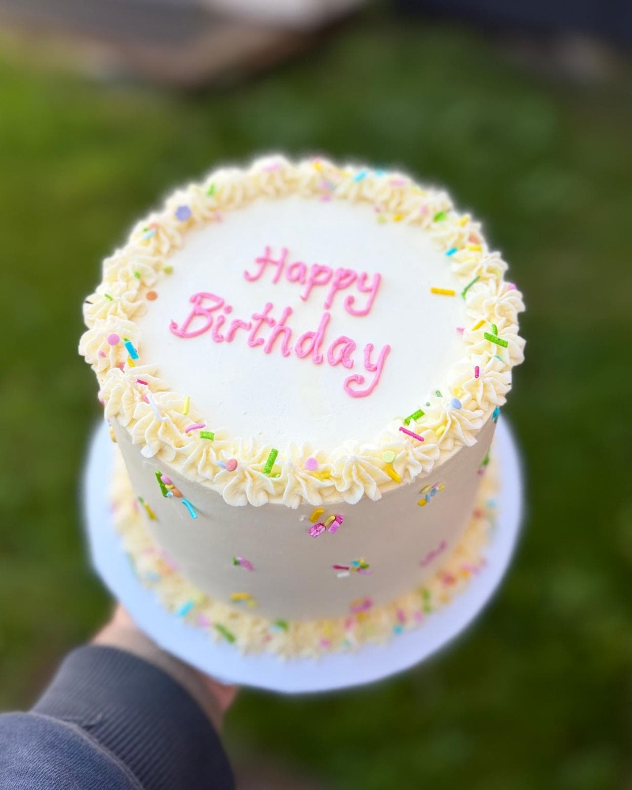 White Happy Birthday cake with pink piping